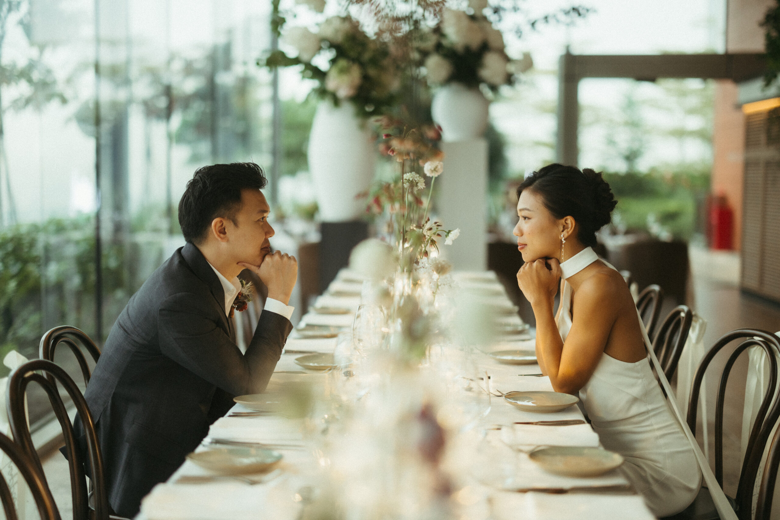 Couple seated at a floral-styled long banquet table at 1-Alfaro